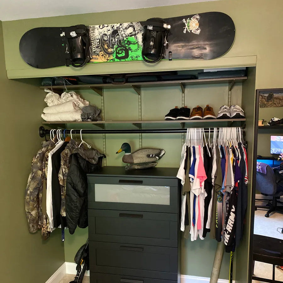 Gabe's afterHIDEit bedroom setup featuring a hunting-themed closet and a snowboard displayed above the wardrobe using the HIDEit HBoard wall mount for organized gear storage.