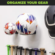 Garage wall with HIDEit Ball-XL Mount holding soccer ball – organize your sports equipment with wall mounted ball holders.