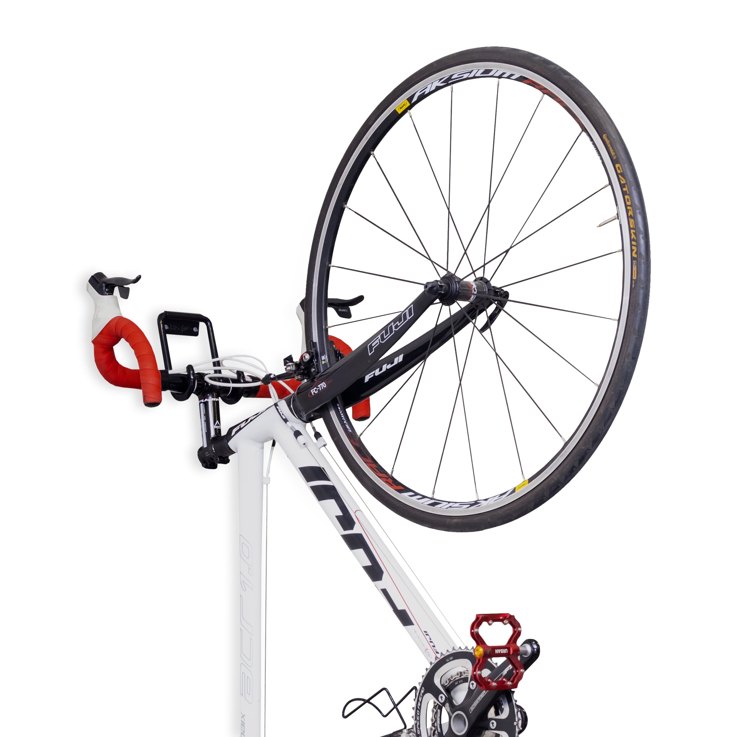 Bike mounted by the handlebars on a HIDEit Bike Hook that's mounted to the wall.