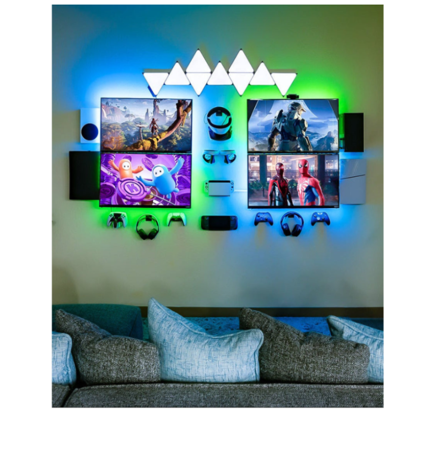 Gaming wall setup with mounted TVs, game consoles, controllers, and headphones, skateboard mounts holding complete boards and decks, and LED accent lighting