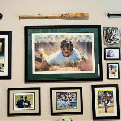 Ernie’s afterHIDEit sports room showcasing framed memorabilia and collector items with baseball bats mounted in HIDEit HBat Horizontal Bat Mounts for a fan cave display wall.