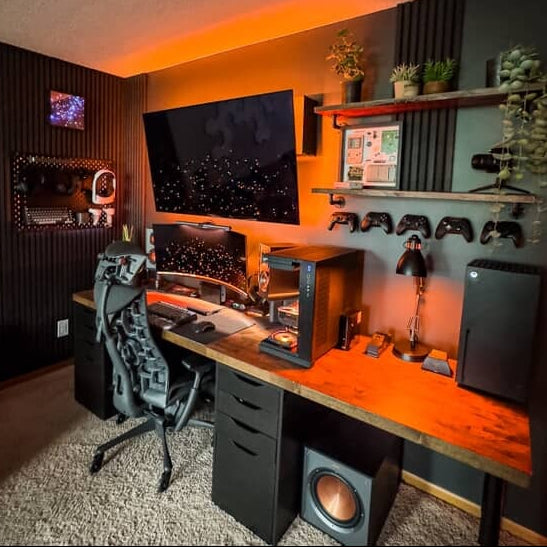retroturbotimmy’s desk gaming setup with floating controller mounts, Series X, keyboard storage, and VR gear organized on a tech pegboard wall.