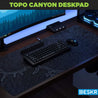 Deskr Black Topo Canyon Deskpad shown on gaming desk.