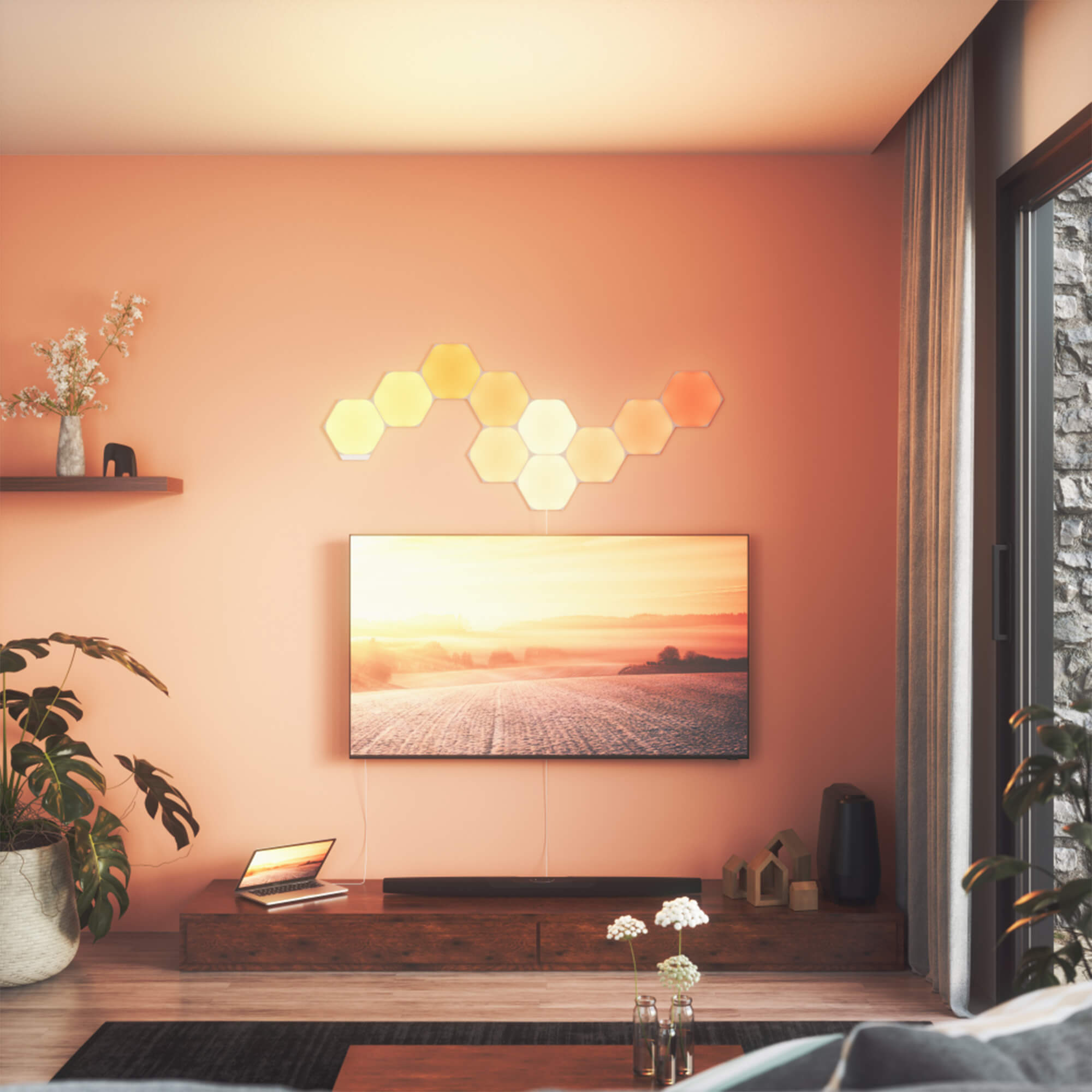 Nanoleaf hexagon lights shown in warm colors lighting up a living room.