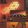 Nanoleaf lines shown in warm colors lighting up gaming desk.