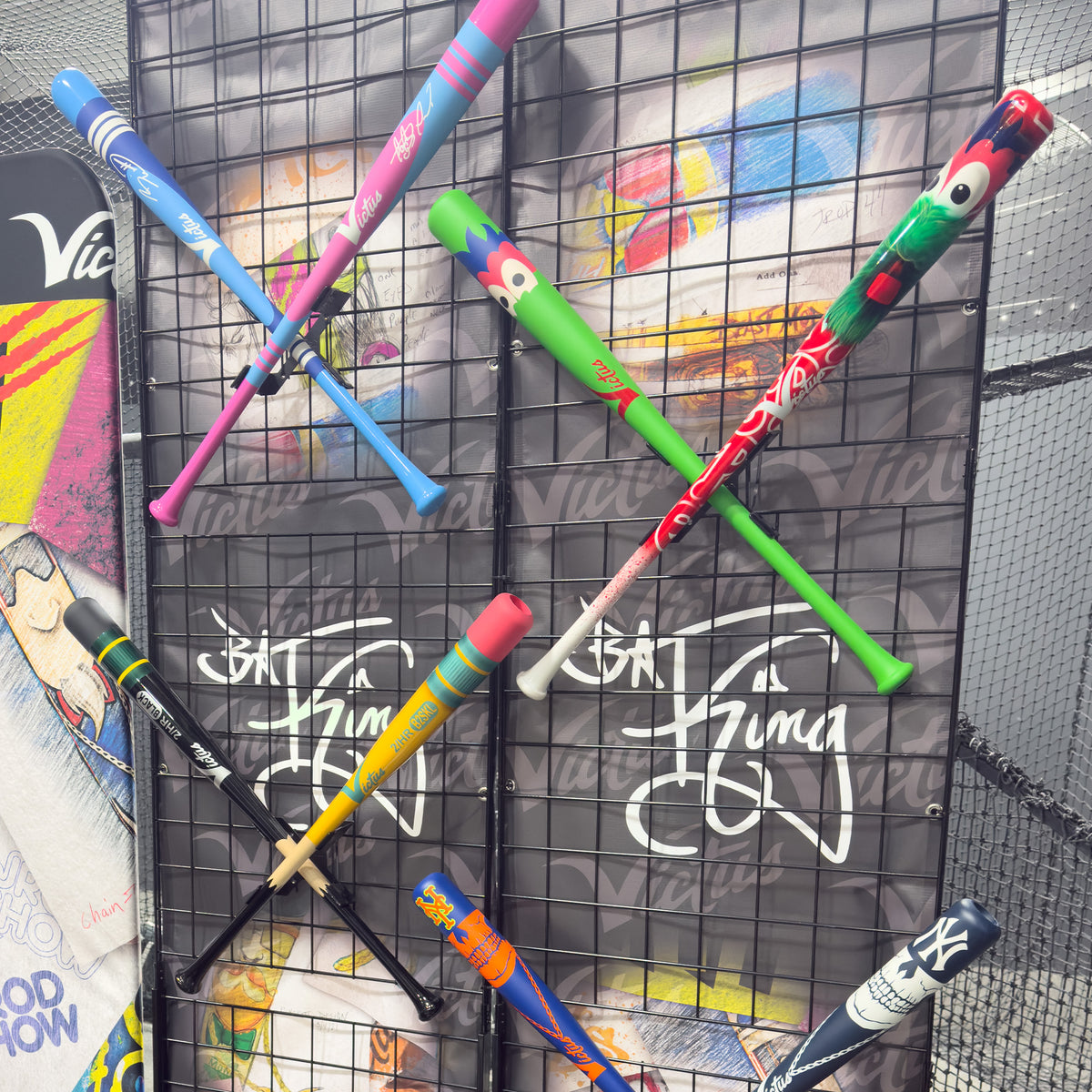 Victus Sports custom bats showcased on a BatKing retail display wall using HIDEit XBat Mounts for vertical bat merchandising and pro shop wall fixtures.