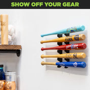 HIDEit Mounts mini baseball bat holder with 5 mini baseball bats displayed on the wall near a wood shelf.