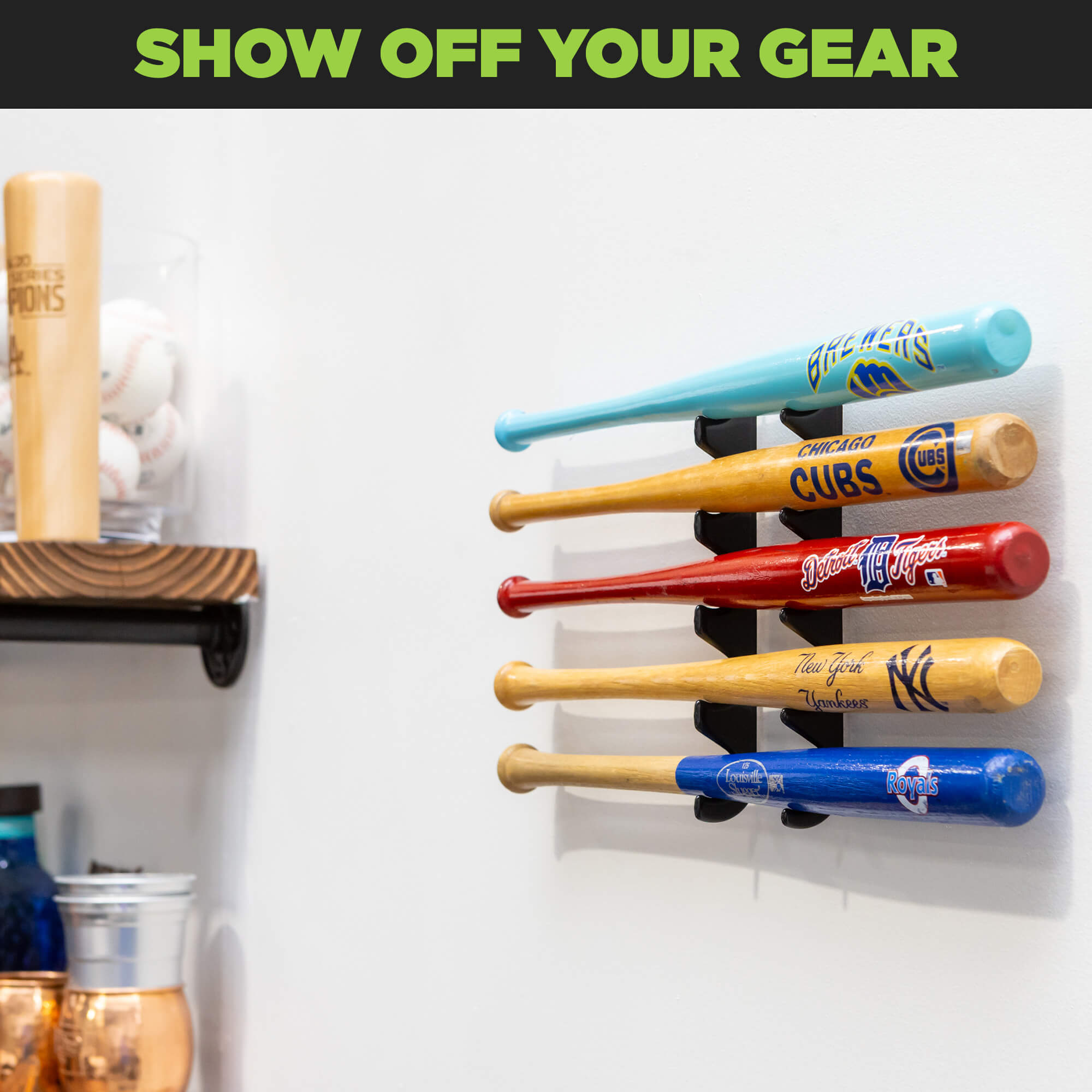 HIDEit Mounts mini baseball bat holder with 5 mini baseball bats displayed on the wall near a wood shelf.