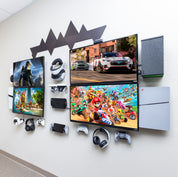 HIDEit headquarters gaming setup at with multiple monitors, controllers, and a gaming consoles all wall mounted using HIDEit Mounts.