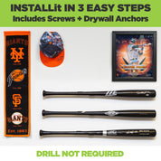 Three black baseball bats mounted to the wall in a steel horizontal baseball bat rack.