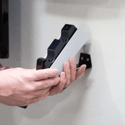 Gif of the HIDEit PS5 DualSense Charging Station Mount being wall mounted. PS5 wireless controllers are put into the PS5 controller charging dock at the end.