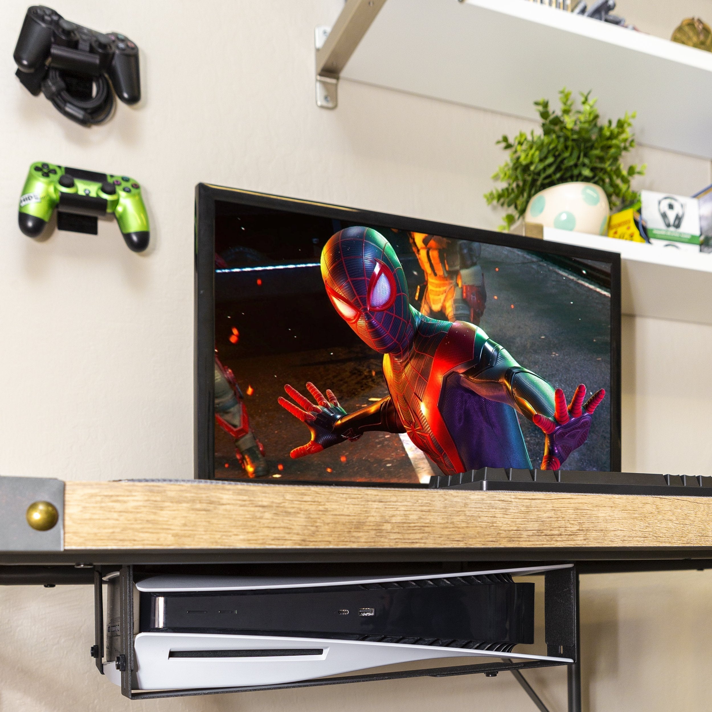 HIDEit Mounts Uni-LXW PS5 under-desk mount with two controller mounts and screen image of Spider-Man: Miles Morales
